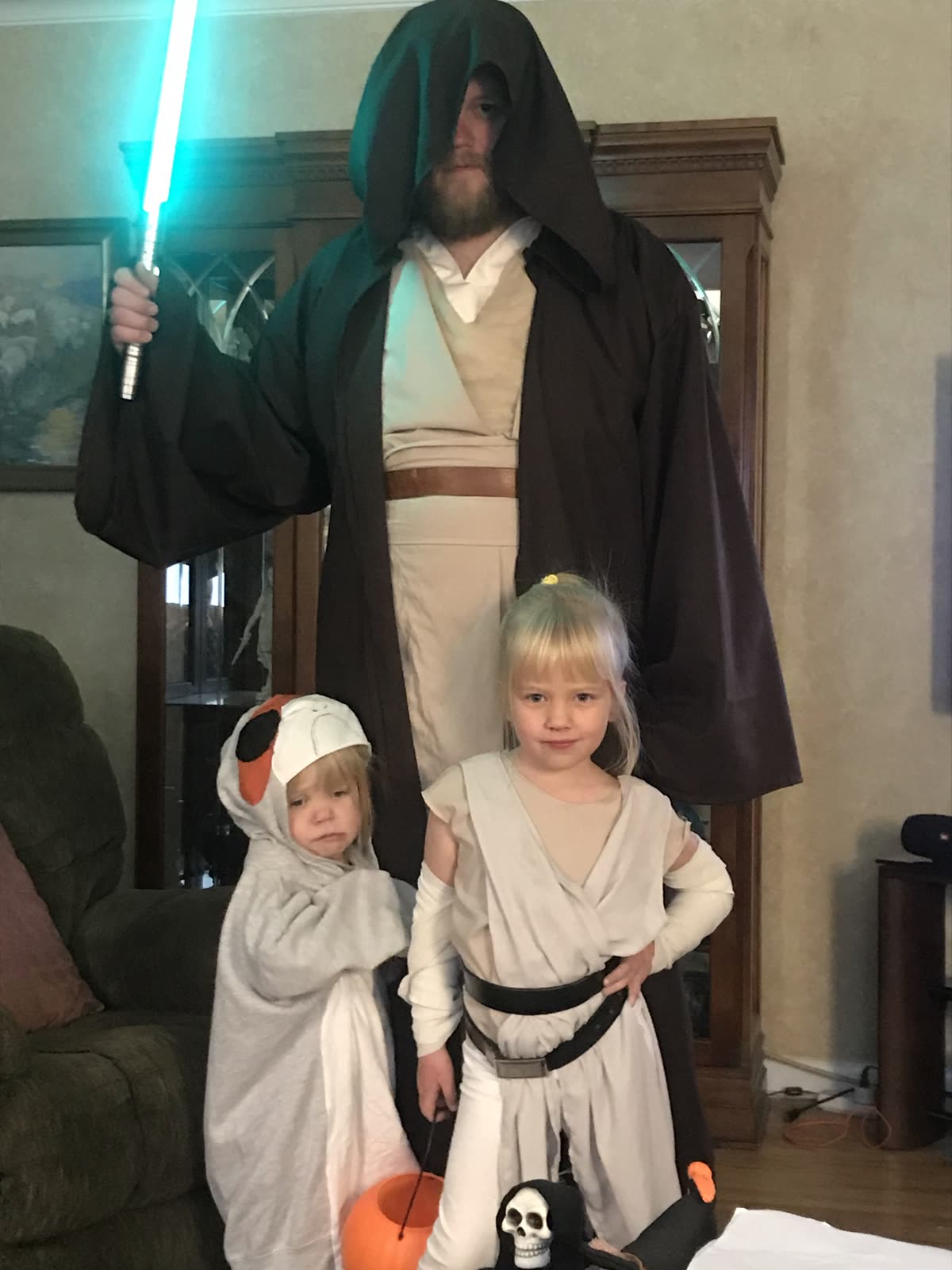 Costumed space knight master with two young padawans in costume